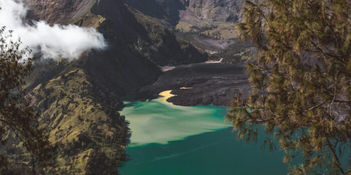 Picturesque turquoise Segara Anak lake located in volcano caldera and surrounded by rocky hills