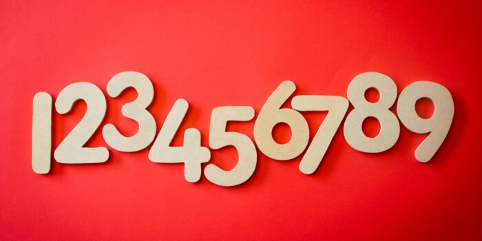 Creative display of numbers one to nine on a vibrant red background, ideal for educational materials.